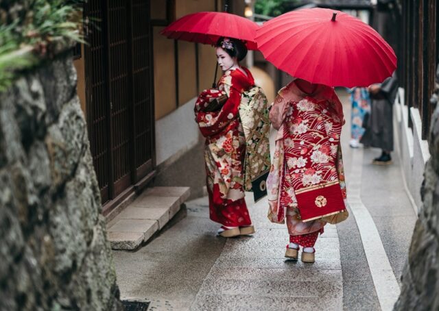 Maiko geishas walking on a street of Gion