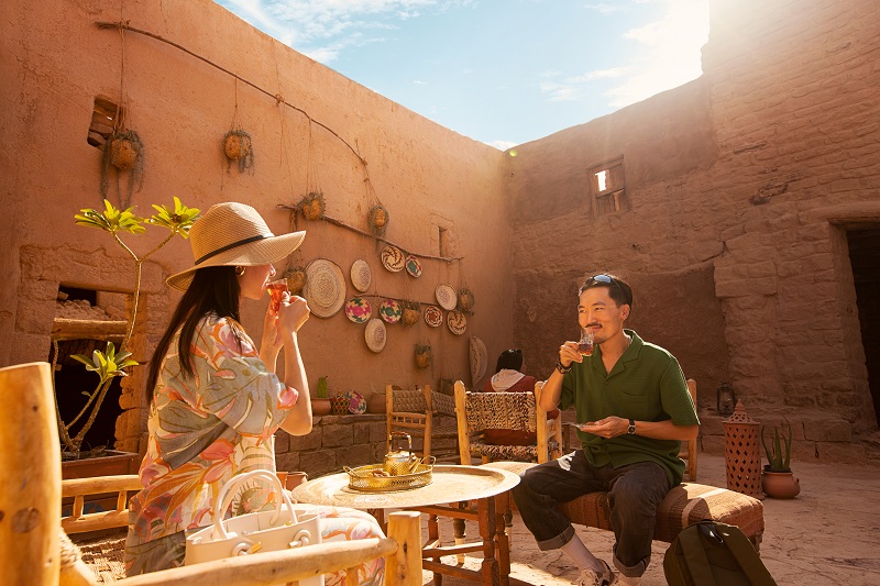 A man and woman drinking tea in Al-Ula Old Town